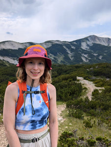 A lady stood infront of mountains