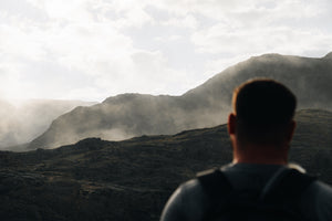 A man looking out to the mountains