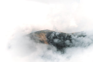 A cloudy background with Scafell Pike peeping through the clouds